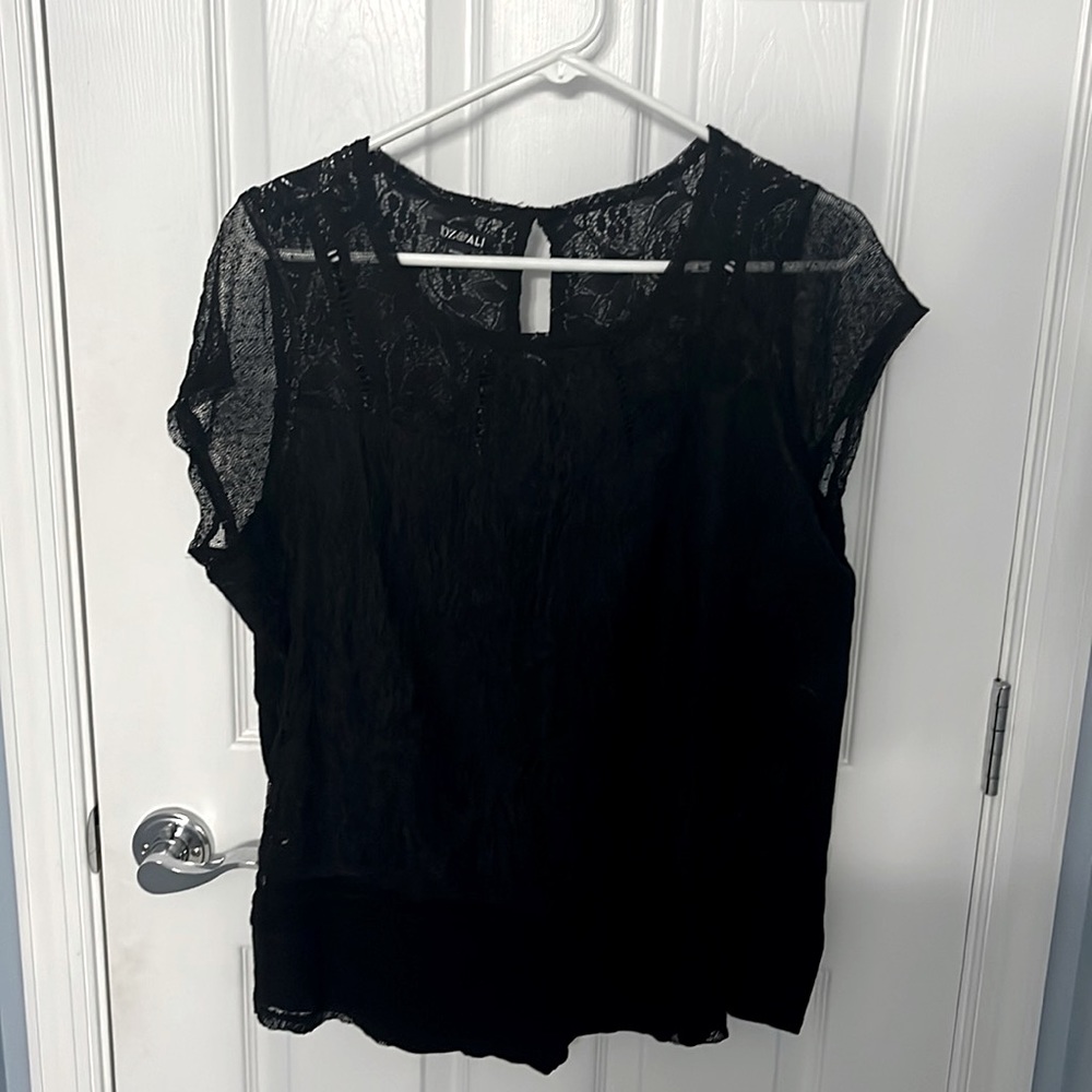 Woman’s short sleeve black blouse.